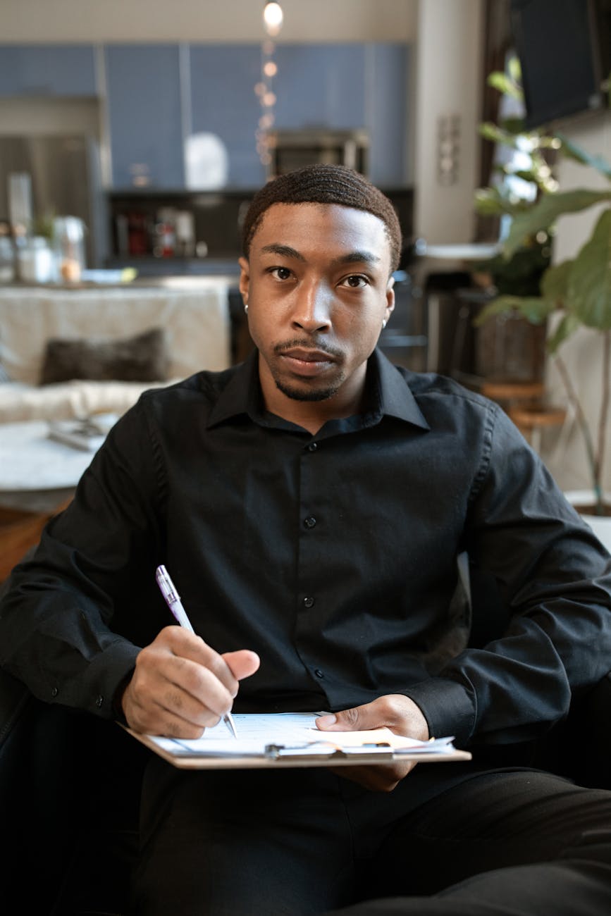 man in black leather jacket holding smartphone
